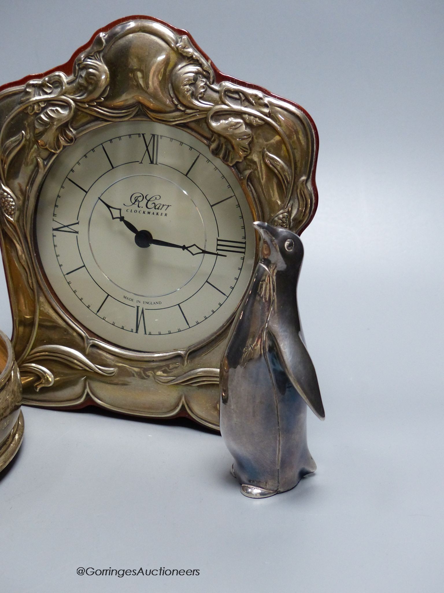 A small R. Carr silver mounted mantel clock, modern, a pair of silver coasters, JB Ld, London 1996, 12.5cm, two Italian penguin ornaments, stamped 990 and a similar 800 standard spoon